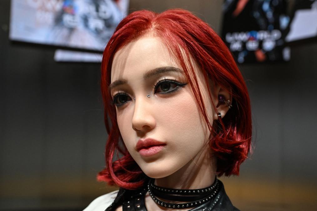 A guest touches a U1 humanoid's face during the Shenzhen launch demo.